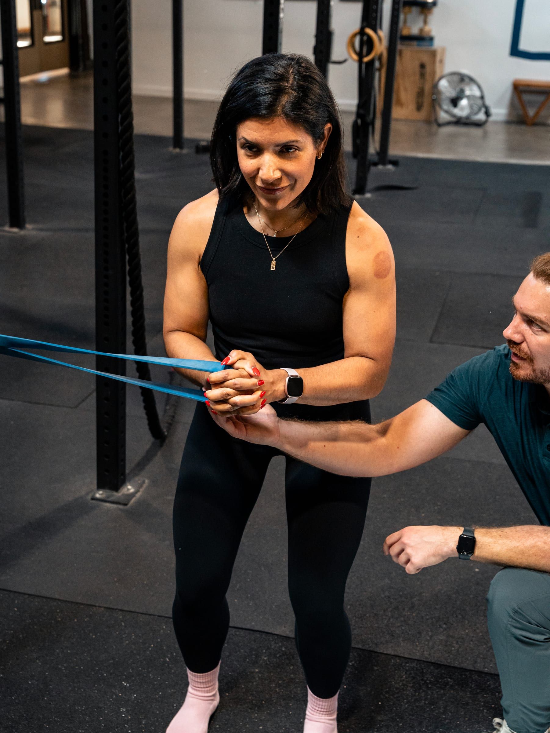 Adam Wilson coaching a banded shoulder exercise