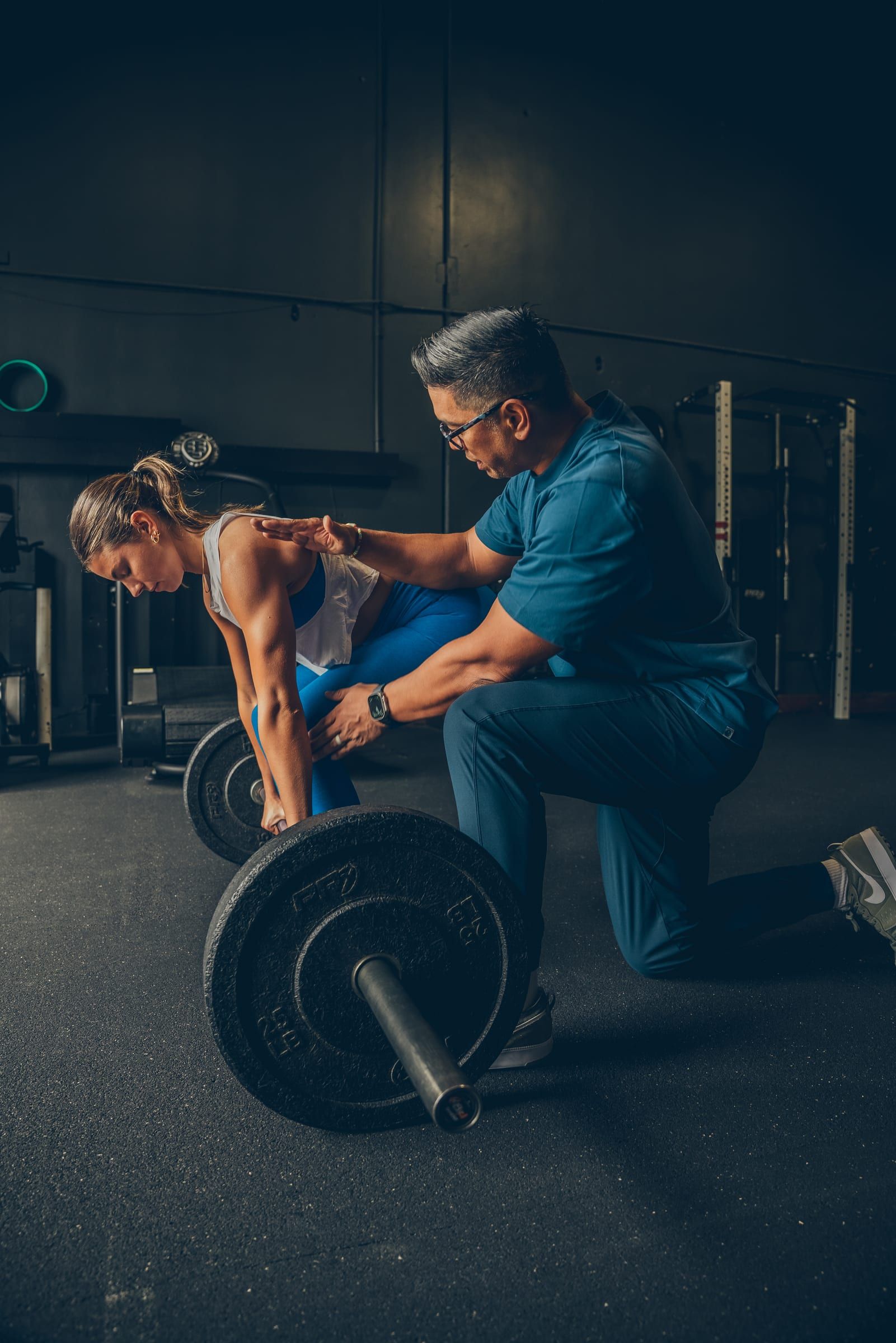 Jay Villareal coaching a client through a barbell deadlift