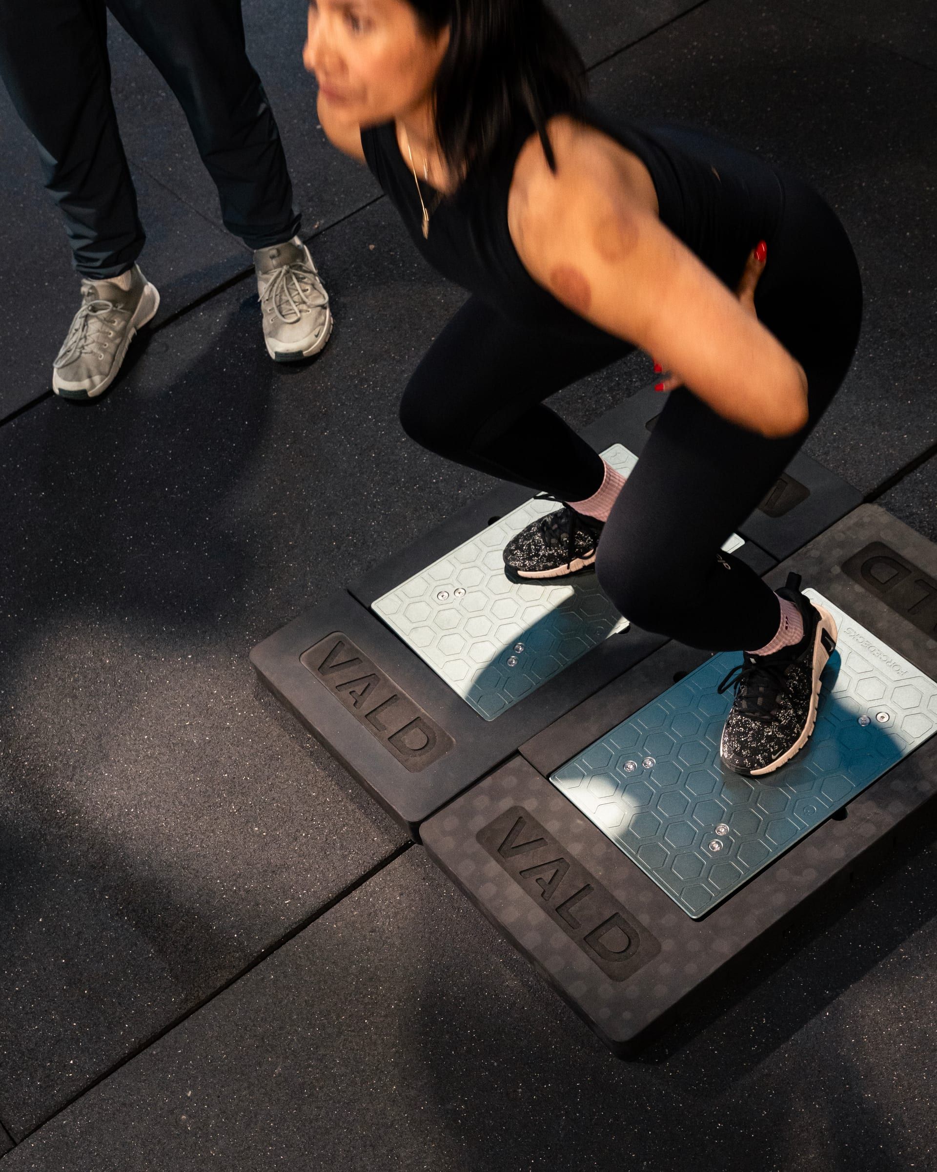 Client performing a single-leg test on force plates