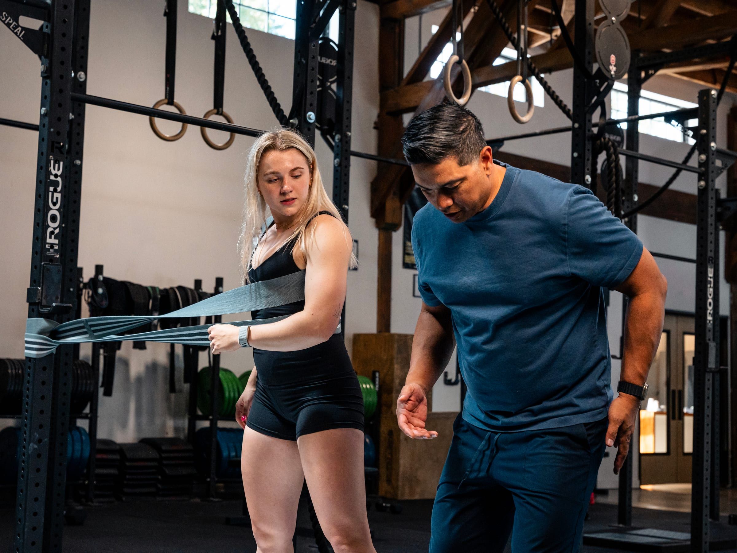 Jay Villareal coaching a client through a banded rotation drill